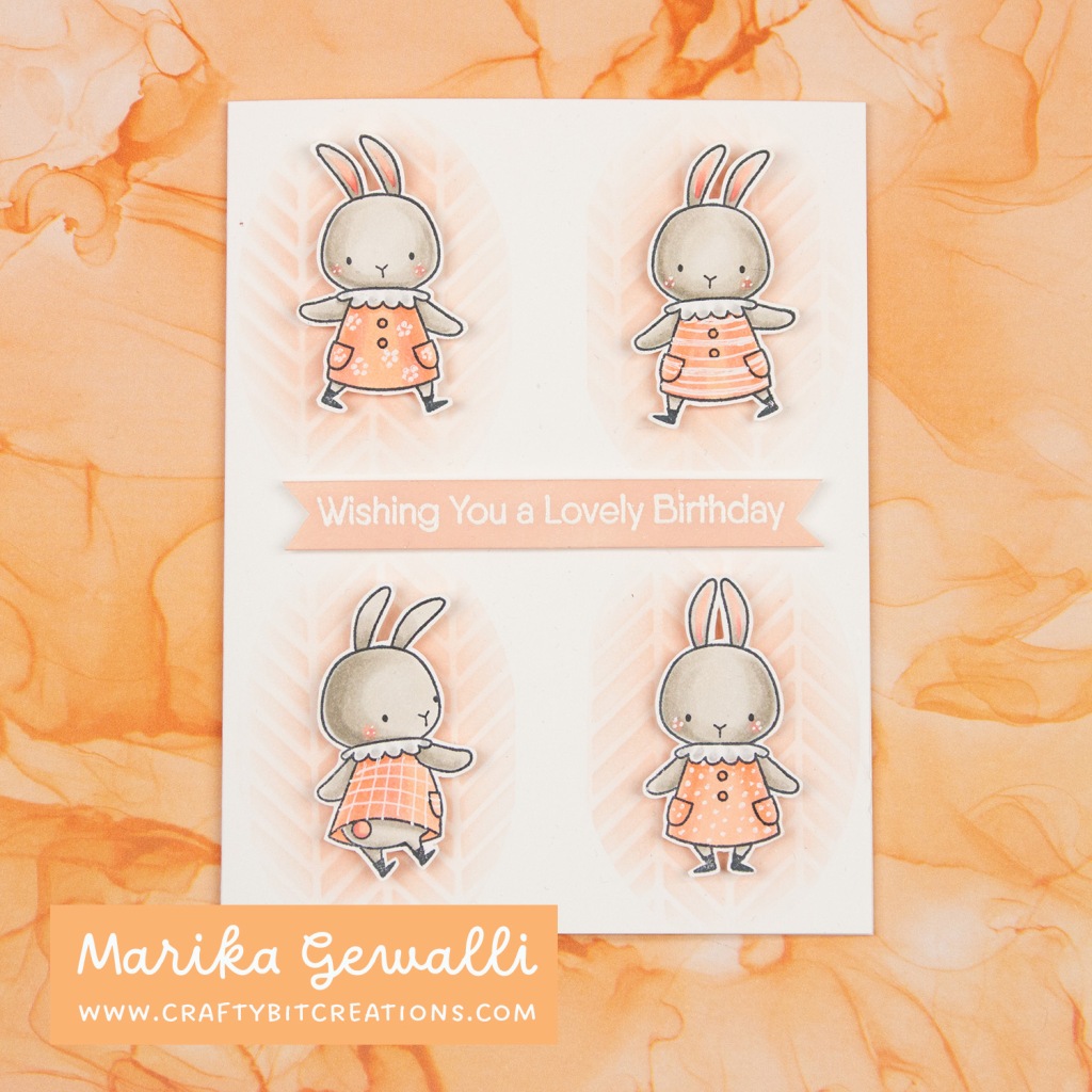 Greeting card for birthday with stamped bunnies with dresses in four corners