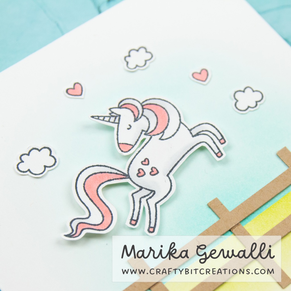 Zoomed in on a cut out unicorn on the top of a greeting card. Colored in white and pink